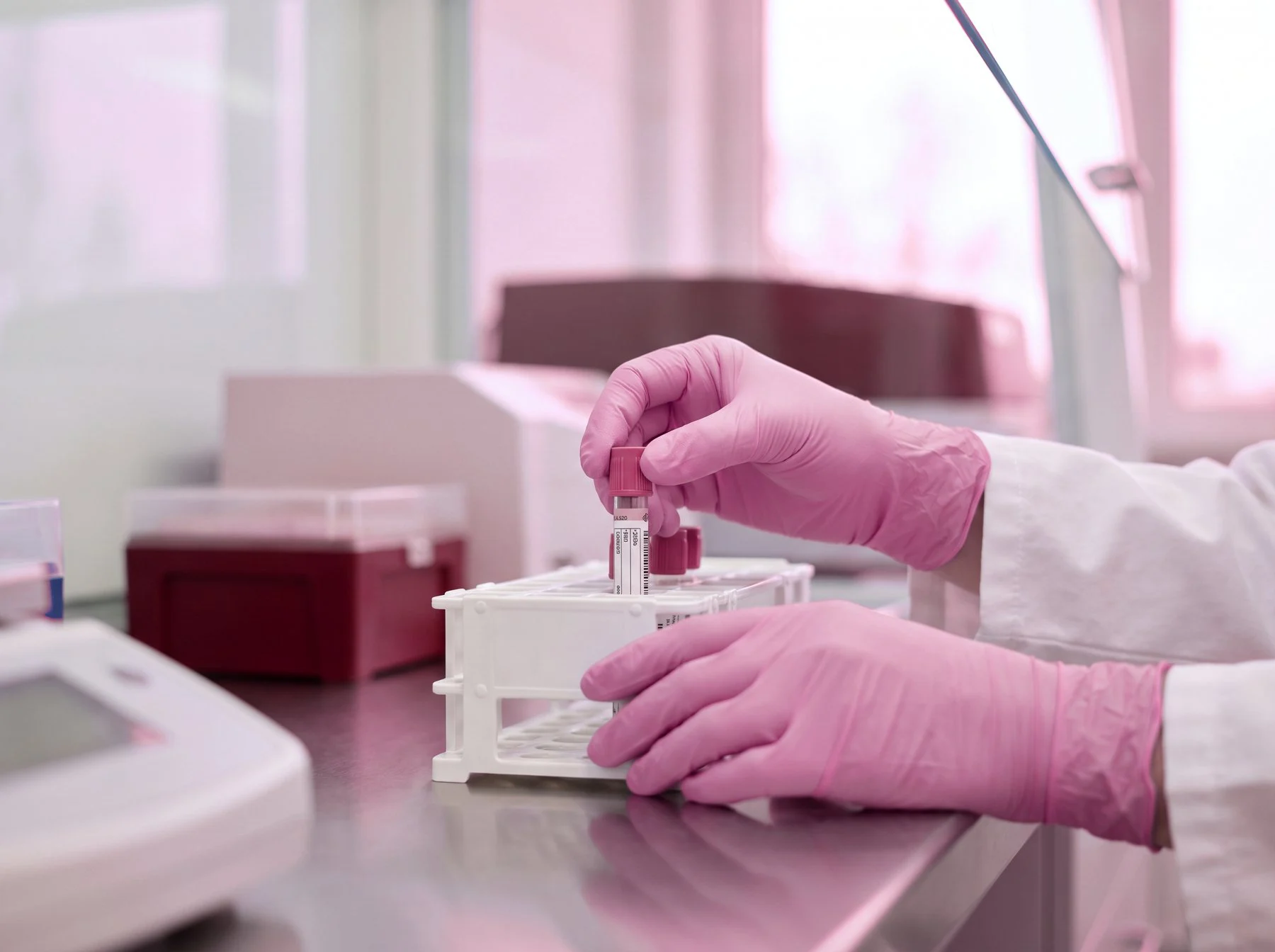 Gloved hands preparing a sample in a laboratory
