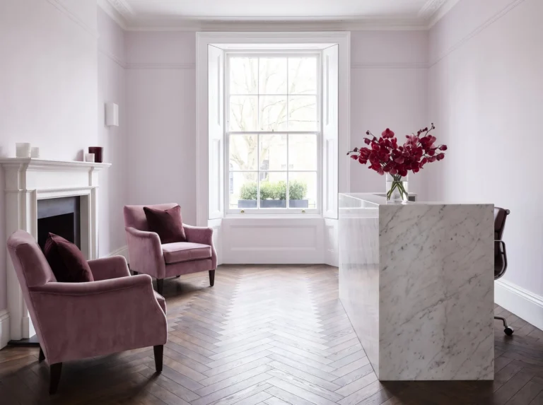 Clinic reception with armchairs, a fireplace and fresh flowers